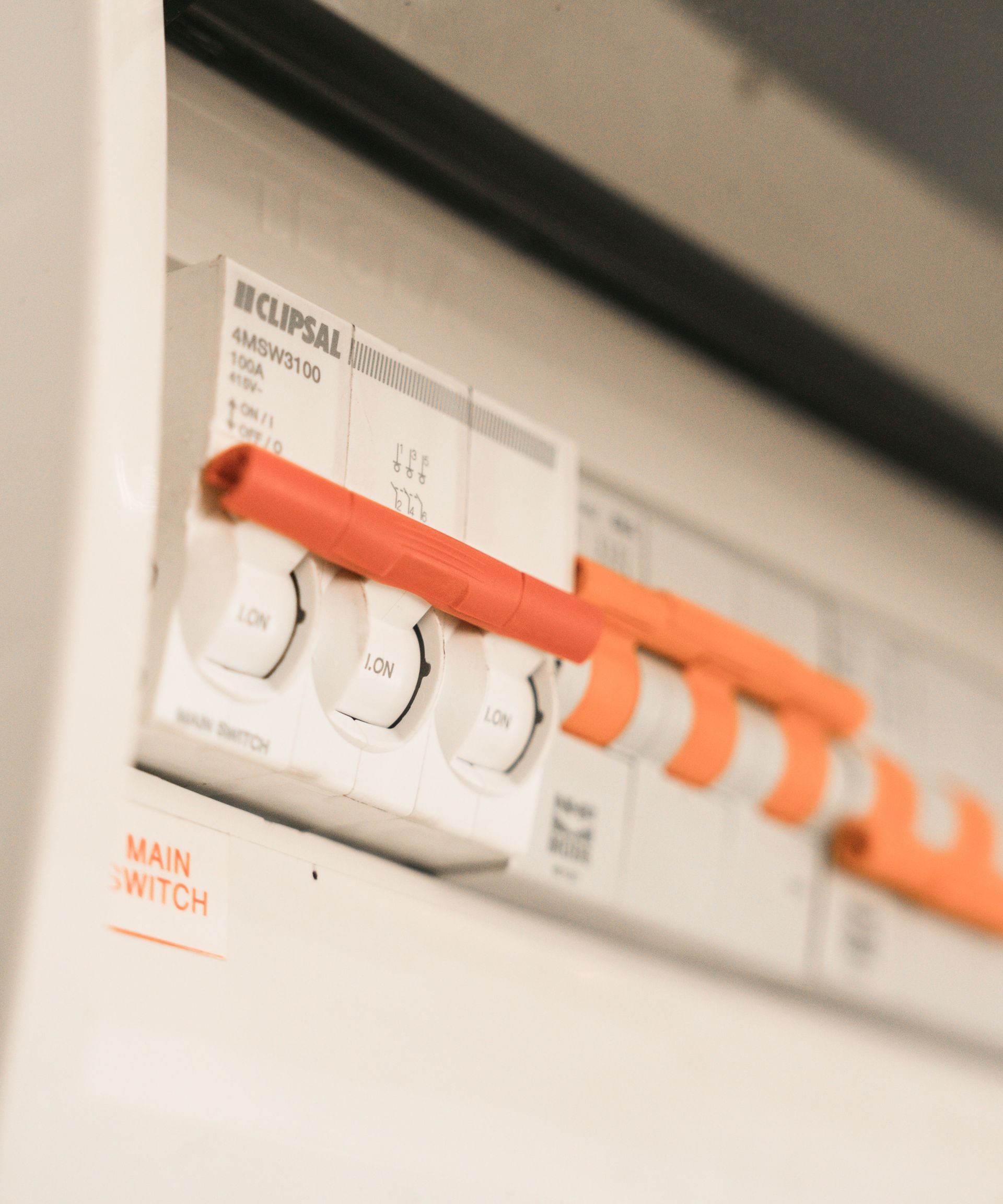 Close-up view of Clipsal electrical circuit breakers in a distribution board.
